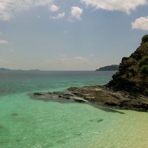 Picture of clear water and white sand from an island near Zamami